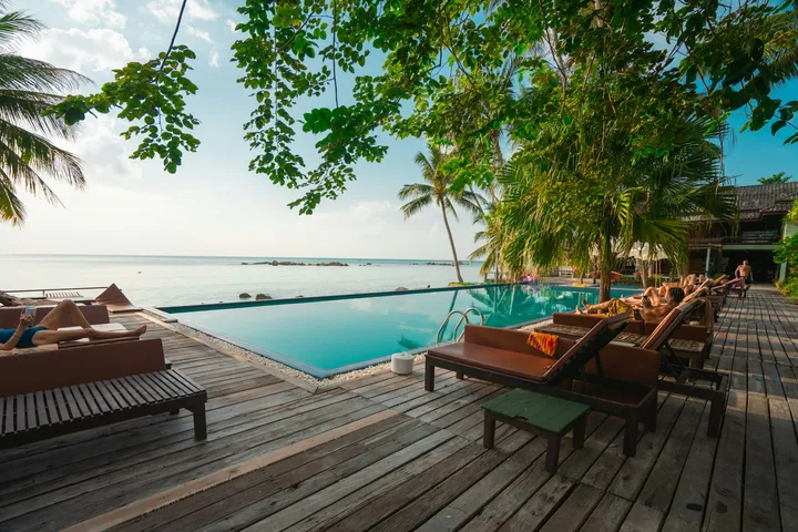 Outdoor stone patio beside a pool